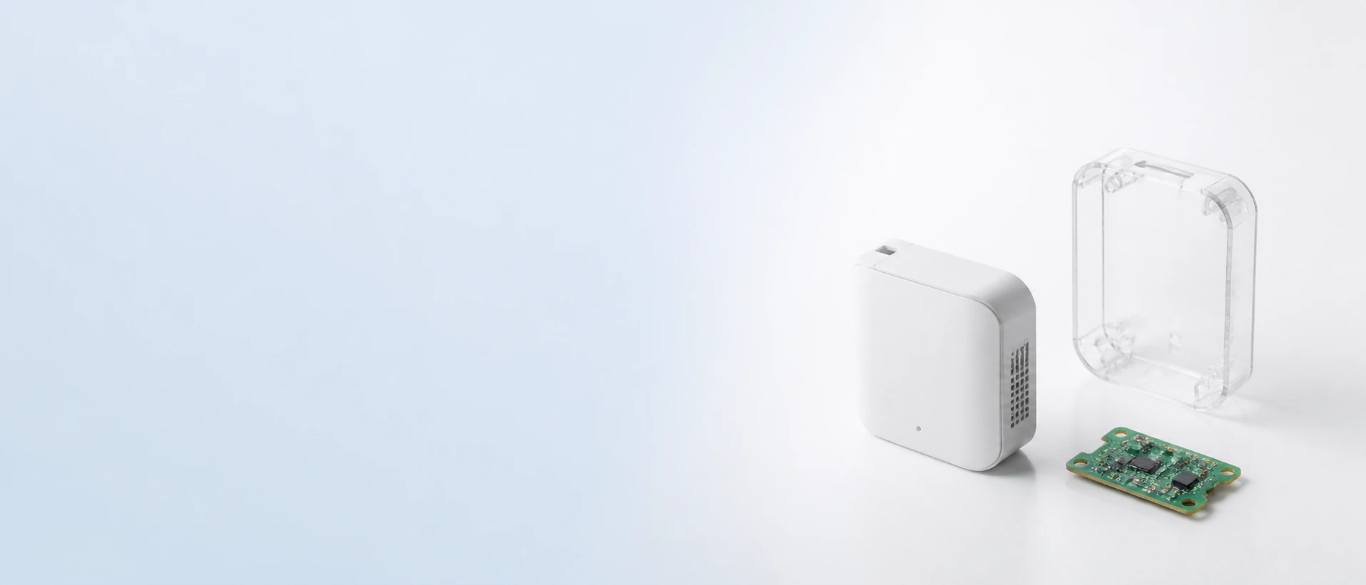 A compact device enclosure, its clear housing shell and the populated control board, arranged side by side